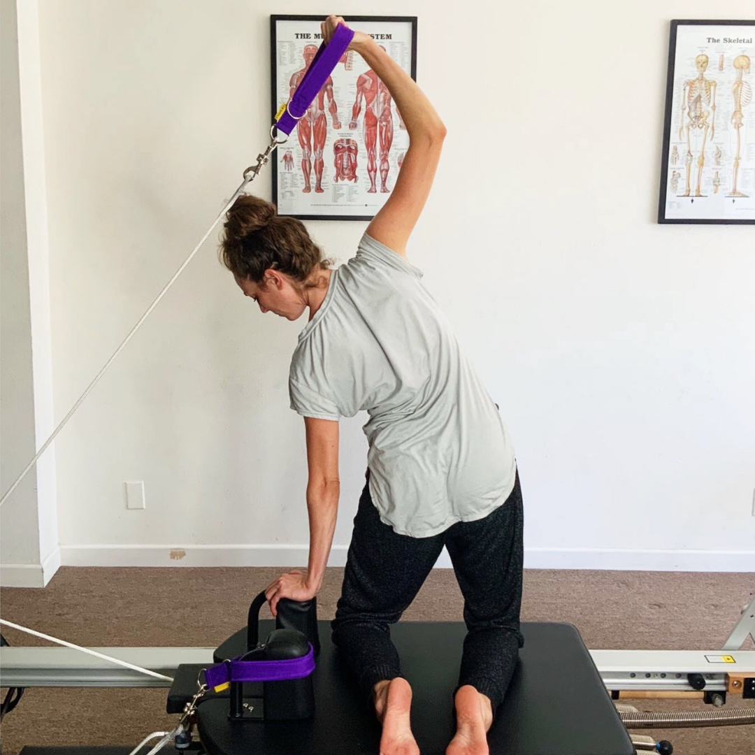 arms semiphore on merrithew reformer with purple padded pilates loops