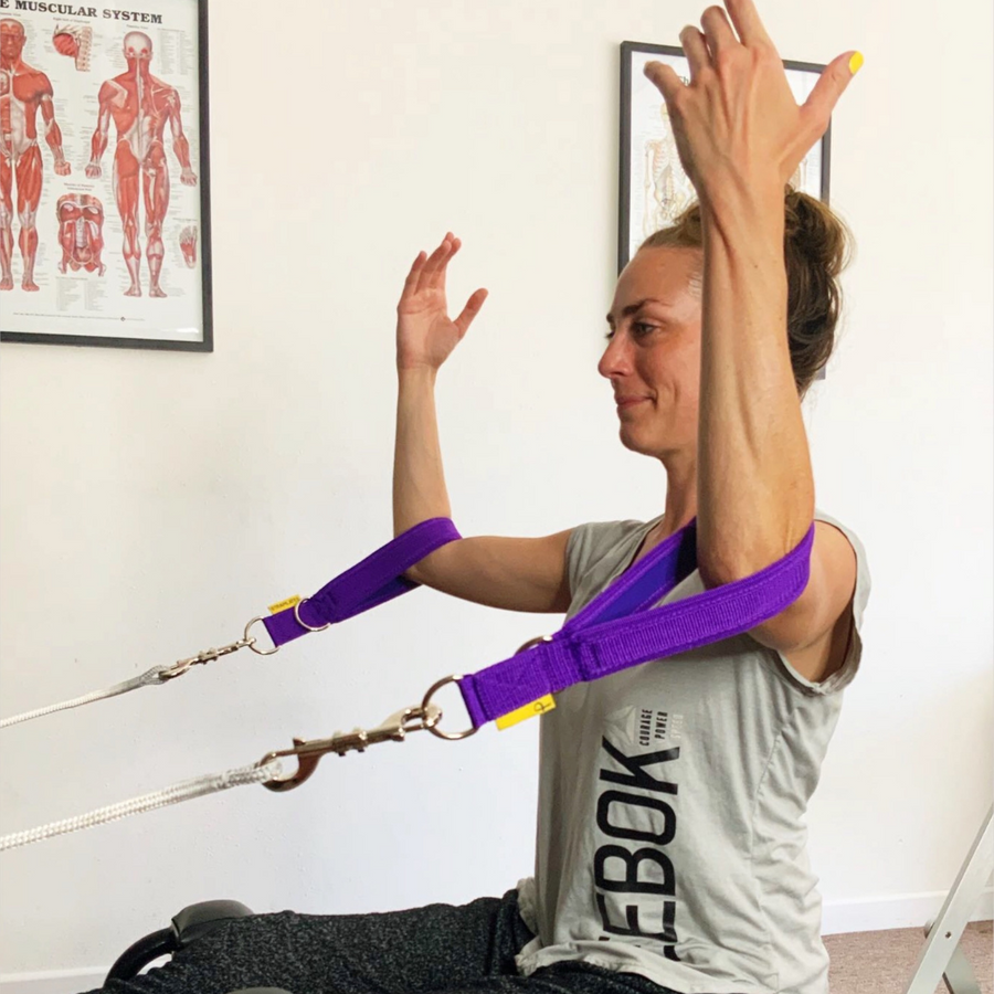 open elbows on merrithew spx reformerwith purple padded pilates loops