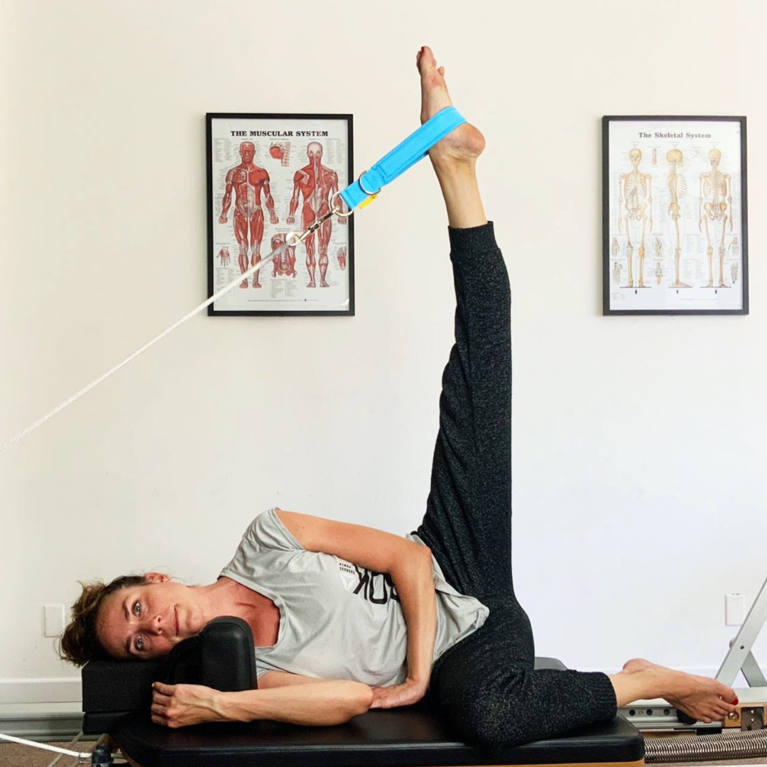 side lying on the V2max reformer with blue padded pilates loops